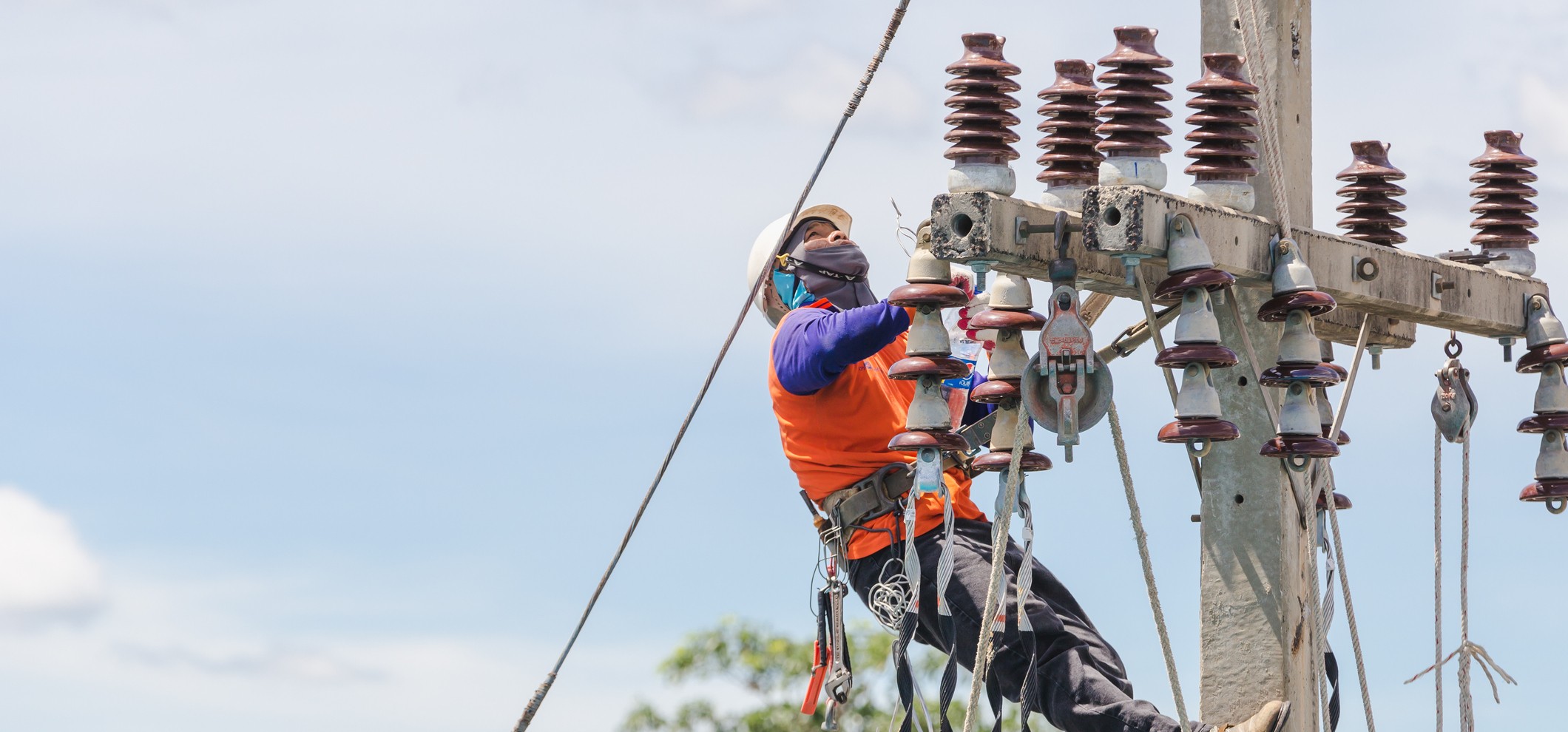 worker on an electric poll